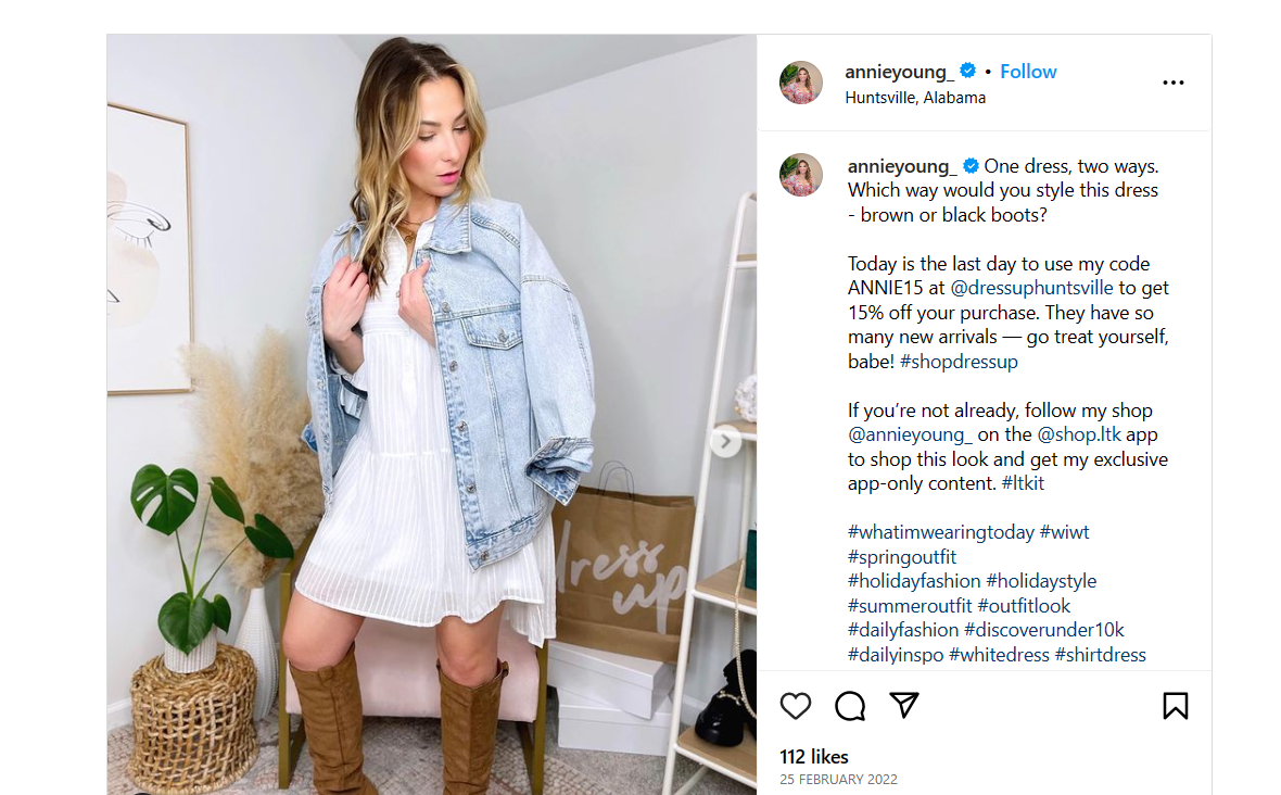 The image shows an influencer dressed in a slightly above knee length white dress with a denim jacket hanging on her shoulders. She can also be seen wearing boots. The caption tells how this dress can be styled in two ways. She also added her unique discount code to get the dress at a discounted price. 